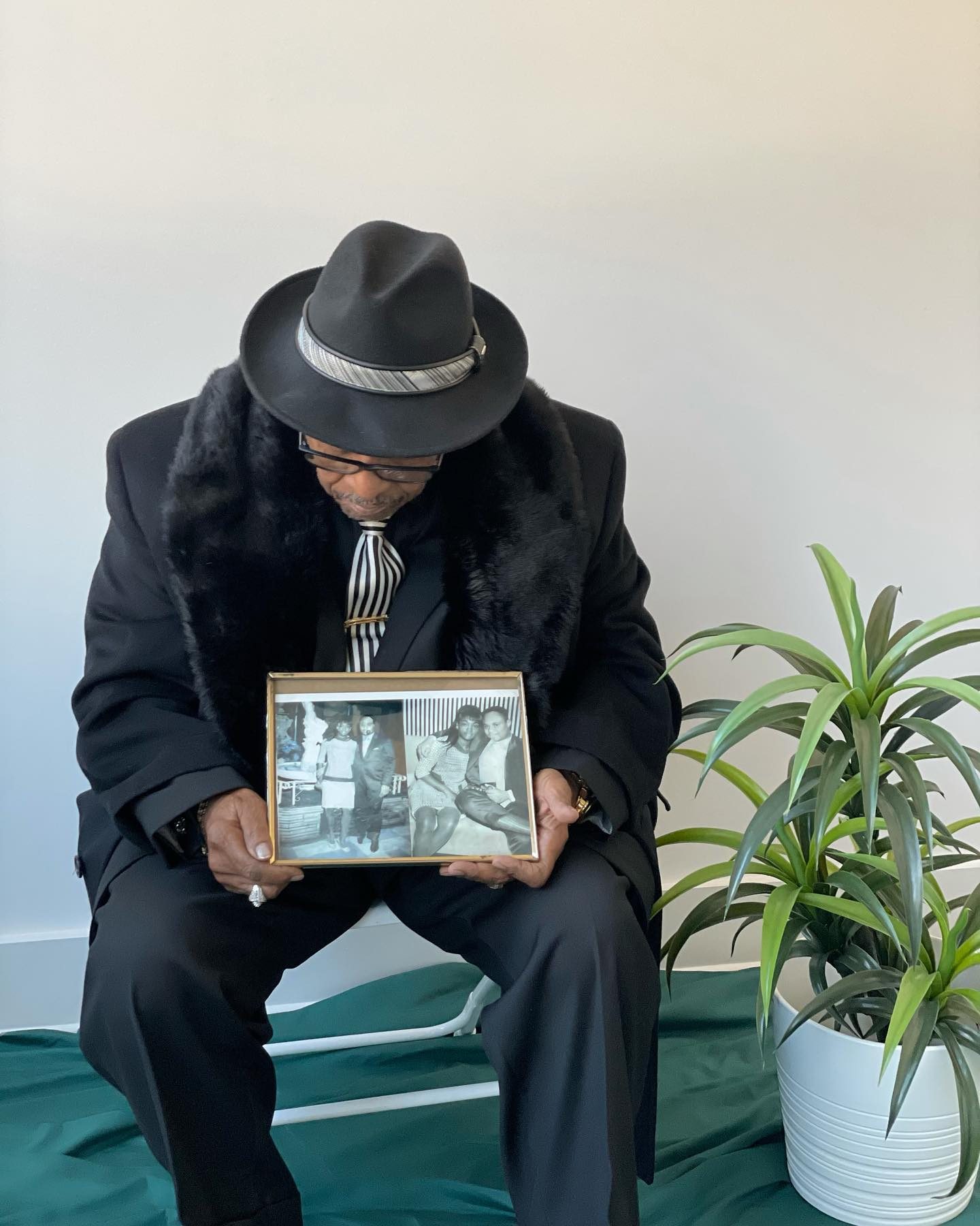 Portrait holding a framed photograph